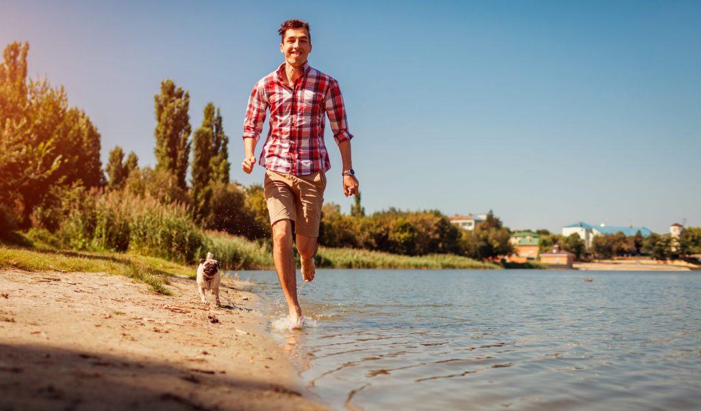 Man on Beach with Pug